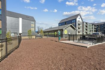 A playground area with a sign that says "BEER HOURS" is surrounded by modern buildings.